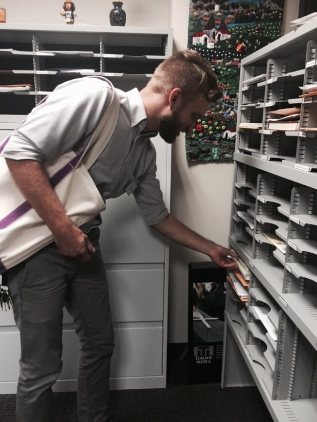 Nathan Wunrow delivers a requested library book to a professor's mailbox. Starting this semester, the library is offering a book delivery service to faculty. (Rachel Weiss/TommieMedia)