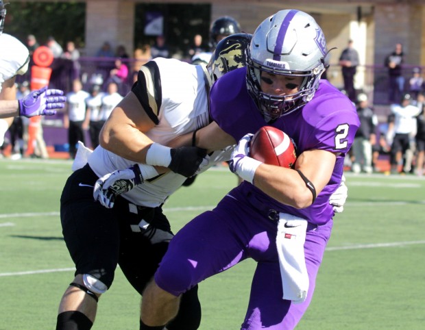 St. Thomas wide receiver Nick Waldvogel fights off an Ole. St.  Thomas leads the Oles 33-0 at halftime. (Andrew Brinkmann/ TommieMedia) 