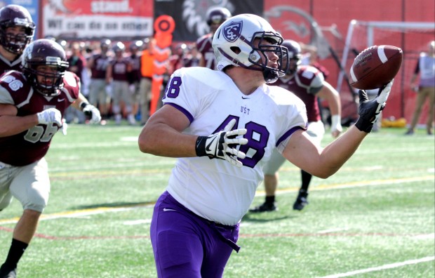 Defensive lineman Ryan Winter intercepts a pass from Auggie quarterback Ayrton Scott. St. Thomas leads at halftime. (Andrew Brinkmann/TommieMedia) 