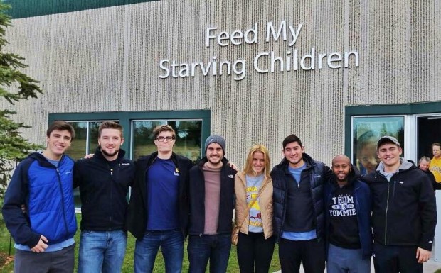Members of Sigma Chi pose for a picture during a volunteering event at Feed My Starving Children. More pictures can be found at Sigma Chi's website. (Photo credit: Sigma Chi)
