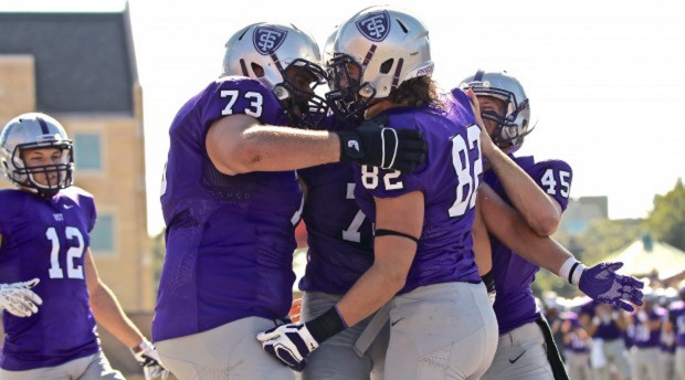 Offensive lineman Michael Greene embraces tight end Jackson Finn after a touchdown. Saturday's halftime score was 27-7 with the Tommies in the lead. (Carlee Hackl/TommieMedia) 