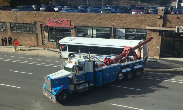 A tow truck removes the commuter bus that collided with two other vehicles Wednesday morning near the St. Thomas campus in Minneapolis. (Photo courtesy of Michael Gaytko)