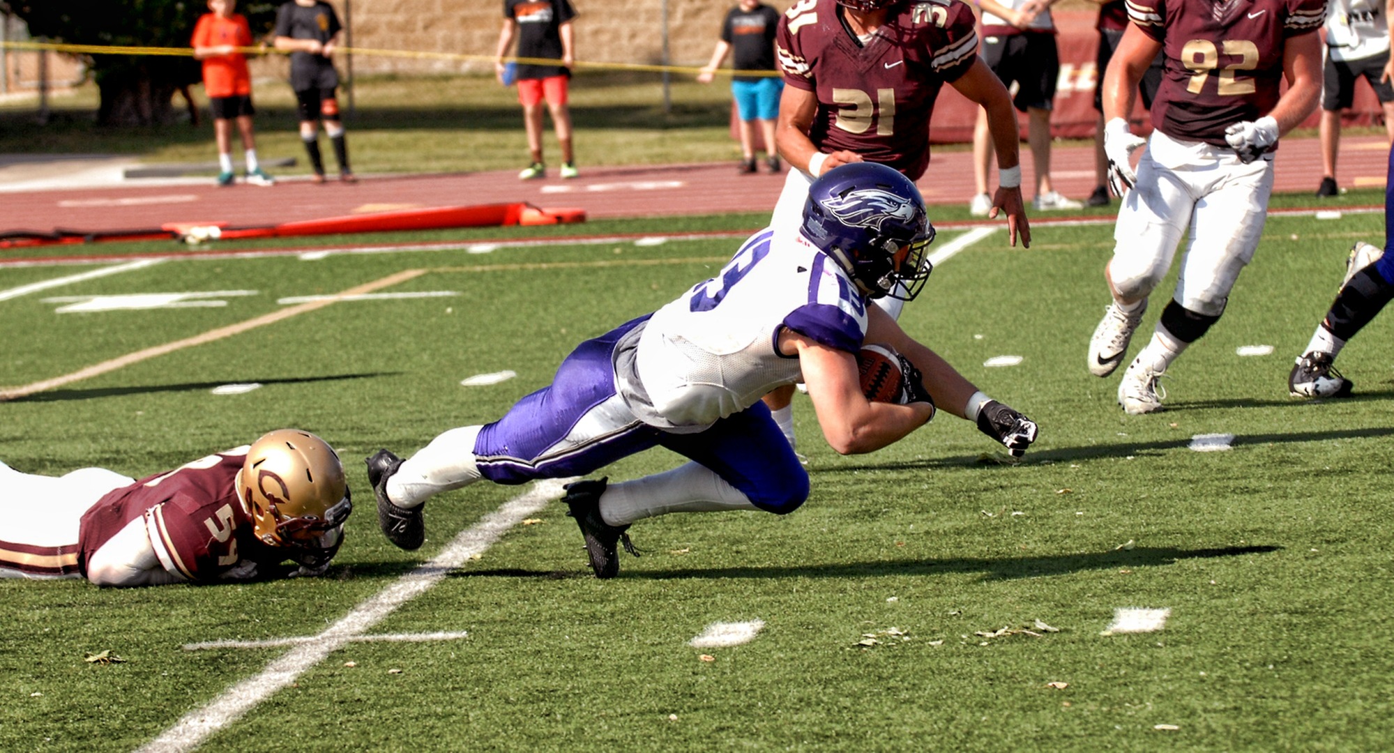 Concordia linebacker Alex Berg (left) trips up Wis.-Whitewater's Drew Patterson on 4th-and-goal in the final minute of the Cobbers' 25-17 victory over the 15th-ranked Warhawks. (Concordia Athletics)