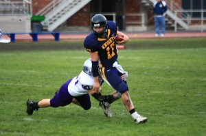 <p>Sophomore Kyle Reynerston takes down the Knights' quarterback for a sack. St. Thomas had a huge second half to top Carleton 48-28 Oct. 24. (John Kruger/TommieMedia)</p>