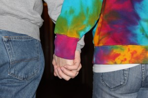Two students holding hands in Koch Commons. (Dan Cook/TommieMedia)