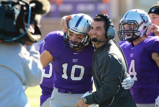 Coach Glenn Caruso embraces wide receiver Pete Fitzsimmons after a Tommie touchdown during last year's game against Augsburg. The Tommies will face the Auggies Saturday at Edor Nelson Field.  (Carlee Hackl/TommieMedia)