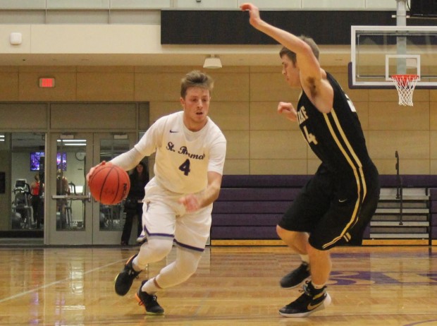 Guard Grant Shaeffer brings the ball down the court for a breakaway lay-up. Shaeffer scored 16 points against St. Olaf. (Lauren Andrego/TommieMedia)