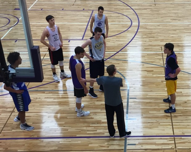Members of the men's basketball team listen to a coach during practice. The Tommies open the season on Nov. 15. (Spencer Flaten/TommieMedia) 
