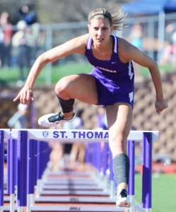 Senior All-American Mallory Burnham focuses over a hurdle in 2013's preliminaries. This year, Burnham advances to Saturday's finals in three events. (Whitney Abrahamson/TommieMedia) 