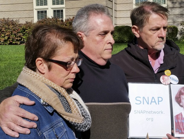 Pat and Dan Harkins stand at a news conference in St. Louis on Thursday, Nov. 10, 2016, joined by David Clohessy, right, of the victims support group Survivors Network of those Abused by Priests. The Harkins' son, Alex, killed himself in 2009, a suicide the parents blamed on sexual abuse by a priest. The family recently settled a wrongful death lawsuit with the Archdiocese of St. Louis. (AP Photo/Jim Salter)