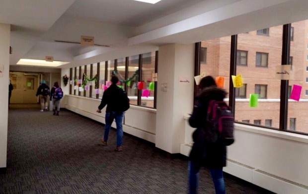 Students walk through the skyway to Morrison Hall and see signs reading #MorrisonLOVES and "Tommies Love not Hate.” The signs  promoted creating an inclusive community on the university campus.(Photocredit Emily Sweeney) 