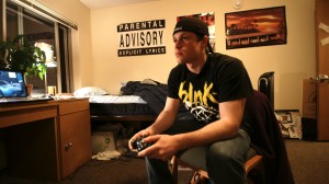 Senior Tony Forneris plays an XBOX 360 in Flynn hall. (John Kruger/TommieMedia)