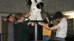 Students from professor Gerry Ruch's astronomy class prep the telescope for use next fall. (Miles Trump/TommieMedia)