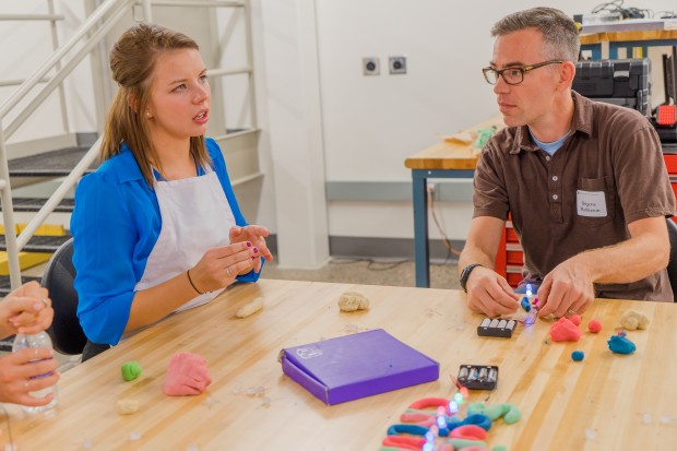 Senior Allison Haugh and event guest Brigette Mathiason play with Squishy Circuits at a Playful Learning Lab event. Every year, 10-15 students in the Playful Learning Lab research ways to use fun to create an engaging classroom. The researchers strive to get the projects out of lab and into real-life learning environments. (Photo courtesy of Kristian Olson) 