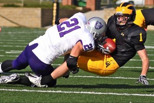 Senior linebacker Brady Ervin tackles a Gustavus wide reciever.