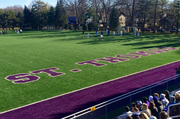 Spectators watch as the Tommies attack in the Saints' zone. St. Thomas beat St. Scholastica 2-1 in double overtime in the first round of the NCAA playoffs.  