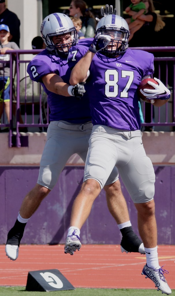 Tight end Jackson Hull and wide receiver Nick Waldvogel celebrate after a touchdown. Hull ran 21-yards after receiving quarterback Alex Fenske's pass to score the team's first six points against University of Wisconsin-Stout. (Natalie Hall/TommieMedia) 