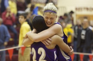 <p>Senior Ali Johnson and sophomore Taylor Young embrace as the Tommies beat the Tufts Knights 83-72 in overtime. (Cynthia Johnson/TommieMedia)</p> 