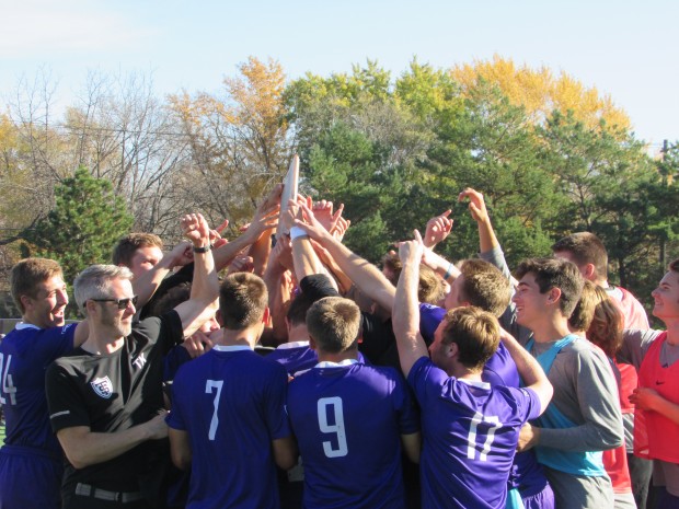 The team hoists its conference championship trophy. The Tommies earned an automatic berth to the NCAA tournament with the win. (Spencer Flaten/TommieMedia). 