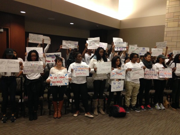 Students display signs at an Undergraduate Student Government meeting to protest club funding and other issues. Representatives from eight multicultural clubs also presented USG with a list of demands. (Grace Pastoor/TommieMedia)