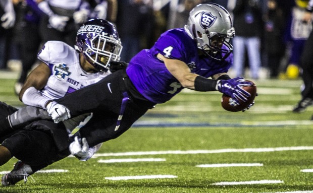 Wide receiver Jack Gilliland dives for extra yards after catching a pass. St. Thomas is tied with Mt. Union 14-14 at halftime of the Stagg Bowl. (Andrew Brinkmann/TommieMedia)  