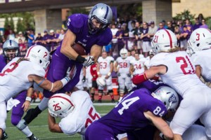 Running back Jack Kaiser leaps toward the end zone without success during last year's Tommie-Johnnie game. St. Thomas faces off against rival St. John's Saturday in Collegeville. (Jake Remes/TommieMedia) 