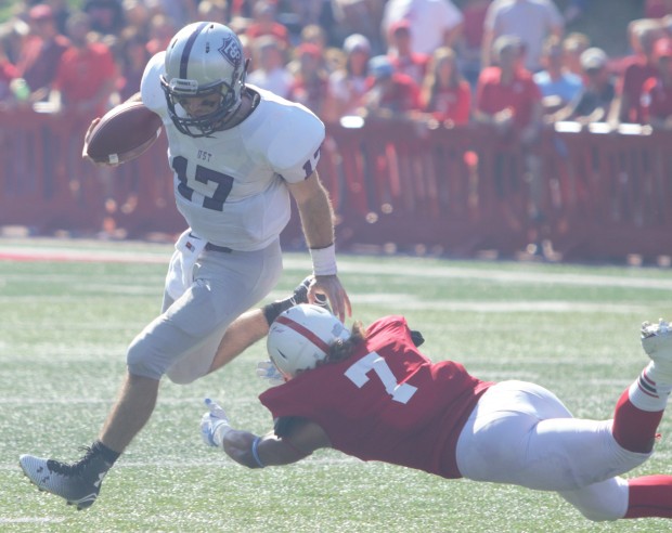 Quarterback John Gould eludes a Johnnie defender. The Tommies and Johnnies are tied 7-7 at halftime Saturday in Collegeville (Andrew Brinkmann/TommieMedia)