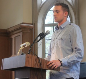 <p>Joe Docter reads a poem at the event. (Rebecca Omastiak/TommieMedia)</p>