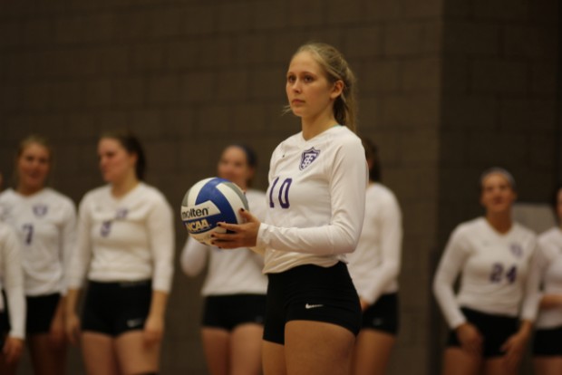 Audrey Erickson waits to serve the ball against St. Olaf last year. The Tommies will be facing harsh cuts this coming season. (Miranda Lockner/TommieMedia) 