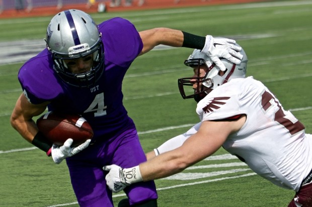 Wide receiver Jack Gilliland stiff-arms a Wisconsin-La Crosse defender during last year's 46-0 win. The Tommies will take on the Eagles Saturday at O'Shaughnessy Stadium. (Jake Remes/TommieMedia)
