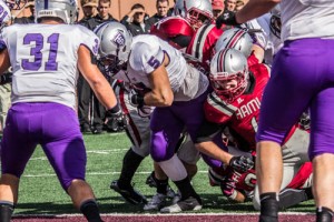 Running back Jack Kaiser breaks the plane for a Tommie touchdown in 2014. The Tommies face Hamline again this Saturday. (Jake Remes/TommieMedia)