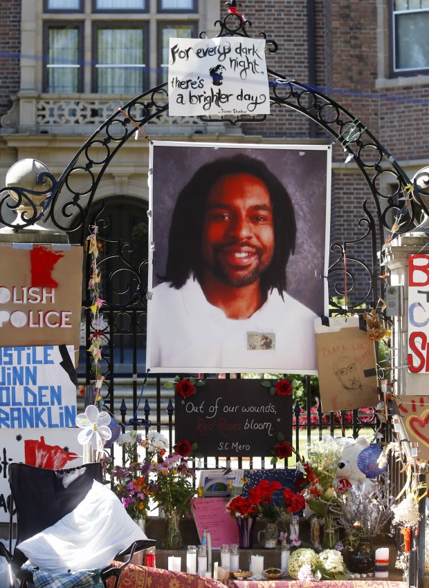 In this July 25, 2016, file photo, a memorial including a photo of Philando Castile adorns the gate to the governor's residence where protesters continued to demonstrate in St. Paul, Minn., against the July 6 shooting death of Castile by St. Anthony police officer Jeronimo Yanez during a traffic stop in Falcon Heights, Minn.
