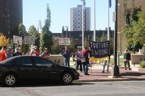 Protest Protesters gathered outside the St. Thomas School of Law Thursday to voice their disapproval of St. Thomas law professor Robert Delahunty and John Yoo, Delahunty's co-author on a series of Justice Department memos. (Katie Broadwell/TommieMedia)