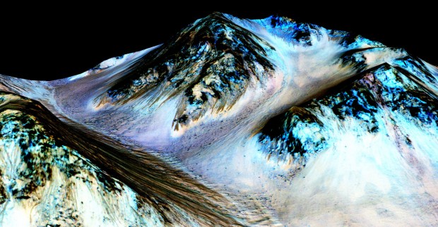 This undated photo provided by NASA and taken by an instrument aboard the agency's Mars Reconnaissance Orbiter shows dark, narrow, 100 meter-long streaks on the surface of Mars that scientists believe were caused by flowing streams of salty water. Researchers said Monday that the latest observations strongly support the longtime theory that salt water in liquid form flows down certain Martian slopes each summer. (NASA/JPL/University of Arizona via AP)
