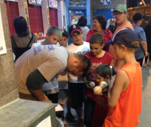 Dylan Thomas signs autographs for fans following one of his first games with the St. Paul Saints Minor League baseball team. Thomas signed with the Saints following a successful career as a pitcher on the St. Thomas baseball team. (Photo courtesy of Ashley Streitz) 