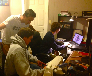 Panacea Cache team members Chris Neuwirth, Josh Balk and Jake Powell, all St. Thomas juniors, work on their graphic designs in the home headquarters. Neuwirth and Powell have been working on the designs since last winter. (Kayla Bengtson/TommieMedia) 