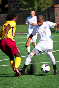 Midfielder Miles Stockman-Willis attempts to beat a defender during a game in late September.  Stockman-Willis transferred to the St. Thomas team this season, after playing for a Division I school last season. (Christina Theodoroff/TommieMedia)  