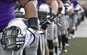 St. Thomas football players line up before an Oct. 26 game against Hamline University. (Eric Wuebben/TommieMedia)