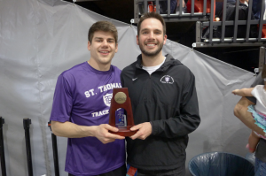 St. Thomas senior Max Dunne displays his All-America trophy with Coach Erik Diley. Dunne was named an All-American in the heptathlon for the second time in his career. (Photo Courtesy of Butch Dunne). 
