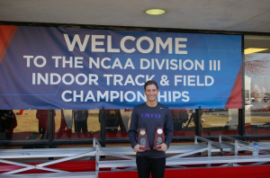 St. Thomas senior Mallory Burnham holds her two All-America trophies. Burnham earned All-American honors this year for the 60m dash and 60m hurdles. (Photo courtesy of Mark Burnham).