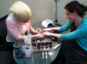 Stylist Amanda Christenson paints graduate student Sarah Snyder's nails at Madison & Co. Salon on campus. The salon opened April 1 and offers haircuts, styles and color along with waxing and nail services. (Michelle Doeden/TommieMedia)