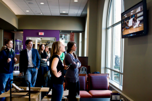 Students watch the Senior Class Gift promotional video in Scooters. The promotional video aired at noon throughout the Anderson Student Center and featured seniors discussing what St. Thomas has given them. (Morgan Neu/TommieMedia)