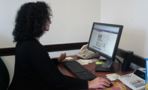 Gina Zitzer, general counsel and chief human resources administrative assistant, works in her office in Aquinas. The Minnesota Senate passed legislation Wednesday that will work to lessen the economic barriers for women. (Rebecca Mariscal/TommieMedia)