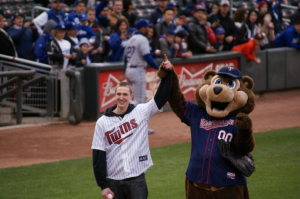 Joe Seifert and Minnesota Twins mascot T.C. Bear celebrate Seifert's first pitch before a May 1 game against the Los Angeles Dodgers. With the help of his RA, Seifert got the chance to throw the first pitch. (Photo Courtesy of Joe Seifert Sr.)