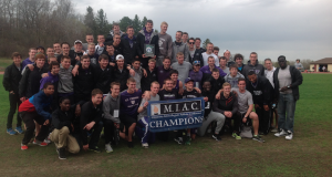 The St. Thomas men's track and field team pose with its MIAC championship banner. The championship is the Tommies' sixth in the past seven seasons (Tom Pitzen/TommieMedia).