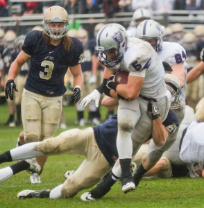 Running back Jack Kaiser busts through the Royal defense during the second quarter. Bethel remained in first place in the conference throughout the remainder of the season, while the Tommies failed to receive an NCAA berth. (Andrew Stafford/TommieMedia)