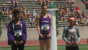 Senior Mallory Burnham accepts her first-place award after the 100-meter hurdles at the NCAA Division-III Outdoor Championships. Burnham placed in the top two of all three of the events she competed in. (Courtesy of Mallory Burnham)
