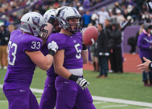 Running back Jack Kaiser flips the ball to the referee after scoring a touchdown against Concordia-Moorhead last fall. Kaiser said he hopes the football team’s momentum will carry over into the 2014 season. (Andrew Stafford/TommieMedia)