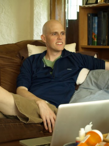 Joe Hall '11 chats with a friend at his home in St. Paul. Hall moved in with his parents after graduation when he was diagnosed with stage four Desmoplastic Small Round Cell cancer. (Caroline Rode/TommieMedia)