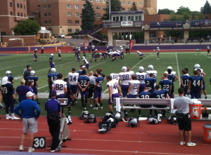 The St. Thomas first-team offense and defense ready for their next play. The football team held its last scrimmage before its season opener Sept. 6. (Tom Pitzen/ TommieMedia)